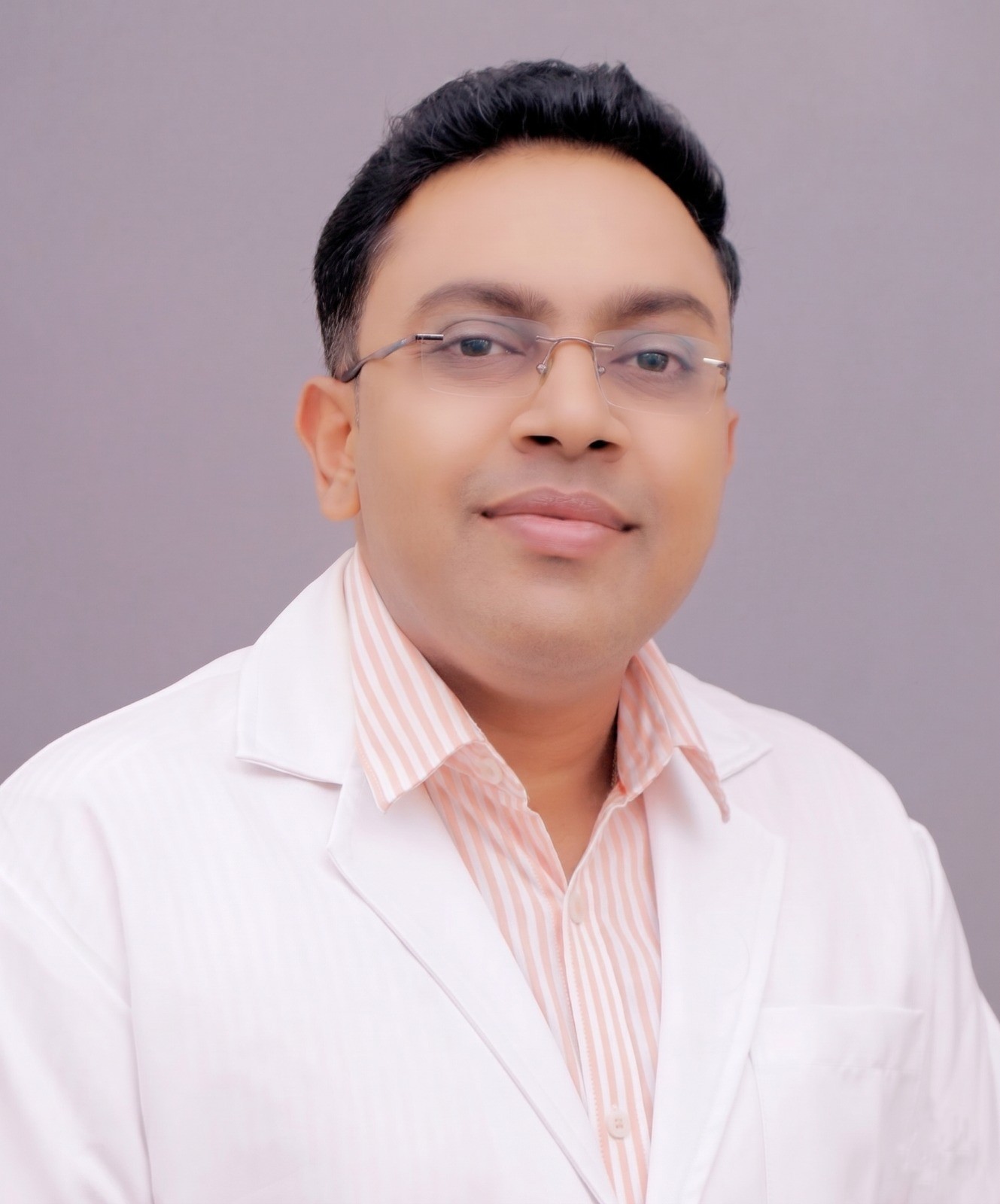 Editorial close-up of a dermatologist's hands holding a dermatoscope while gently examining a patient's skin at COSMALIFE SKIN CLINIC, Bengaluru